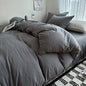Dark blue solid cotton bedding set with duvet cover and pillowcases on a king-size bed, ideal for single, couple, or double beds.