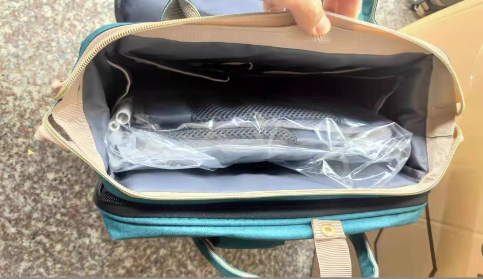 Dark blue large-capacity mommy bag with multiple compartments and adjustable straps, designed for moms to carry essentials.