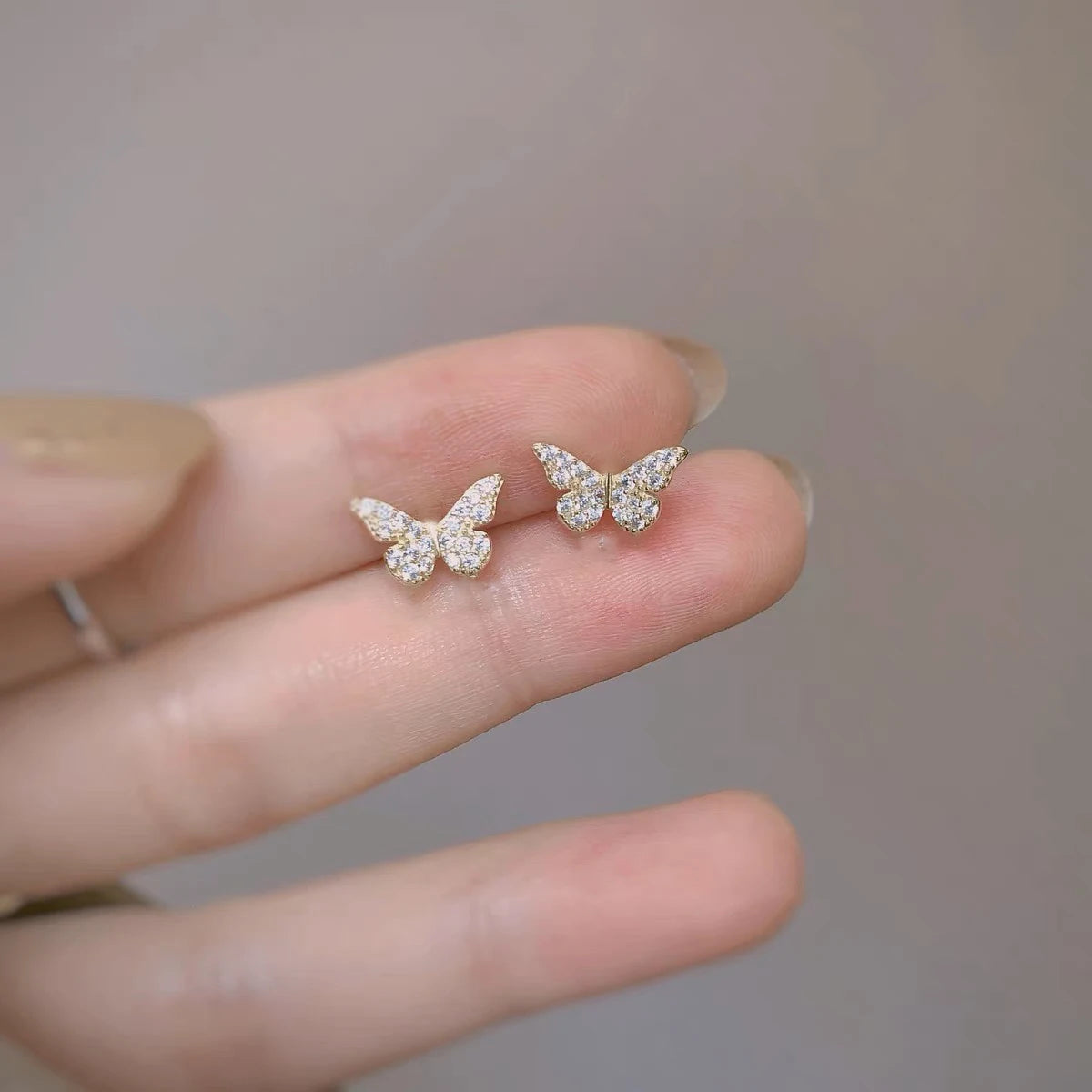 Silver butterfly stud earrings for women, delicate jewelry by ANENJERY, perfect for girls and gift-giving.
