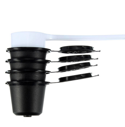 Set of four reusable coffee capsules with a coffee spoon, durable stainless steel, ideal for eco-friendly coffee brewing.
