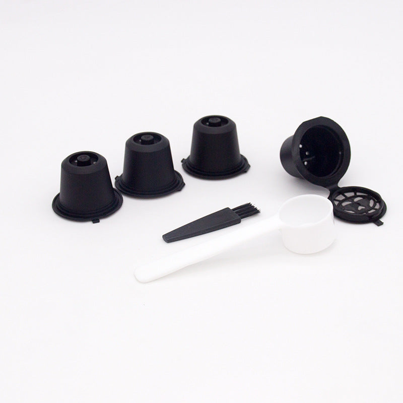 Set of four reusable coffee capsules with a coffee spoon, made by BackupMyFilesNow.com for eco-friendly brewing.