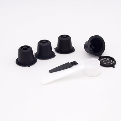 Set of four reusable coffee capsules with a coffee spoon, made by BackupMyFilesNow.com for eco-friendly brewing.