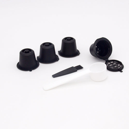 Set of four reusable coffee capsules with a coffee spoon, made by BackupMyFilesNow.com for eco-friendly brewing.