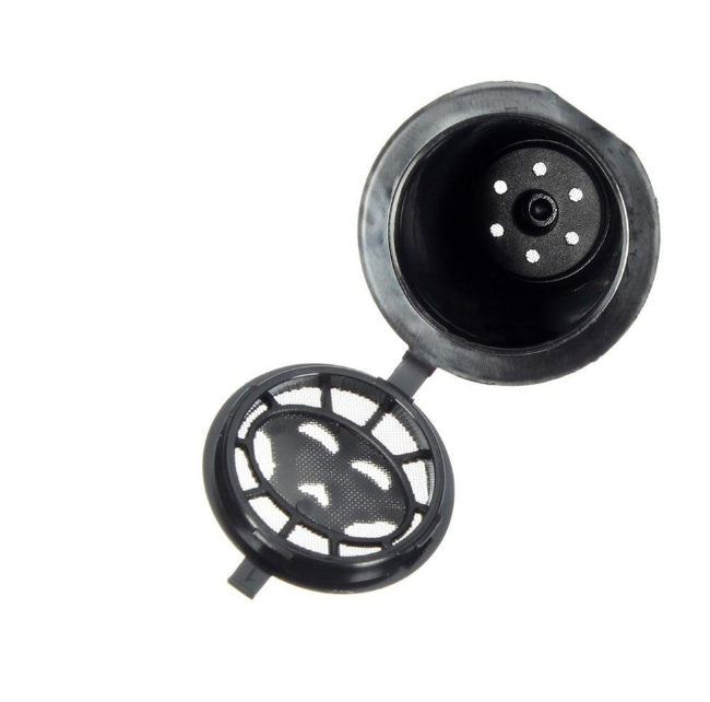 Set of four reusable coffee capsules with a coffee spoon, ideal for eco-friendly coffee brewing.
