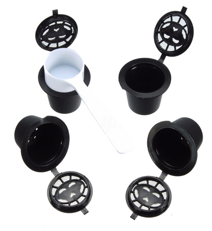 Set of four reusable coffee capsules with a coffee spoon, durable stainless steel design for eco-friendly brewing.