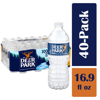 Four 16.9 fl oz bottles of Deer Park 100% natural spring water from BackupMyFilesNow.com® arranged together.