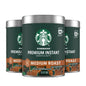 Three 3.17 oz tins of Starbucks Premium Instant Coffee with medium roast Arabica beans on a plain background.