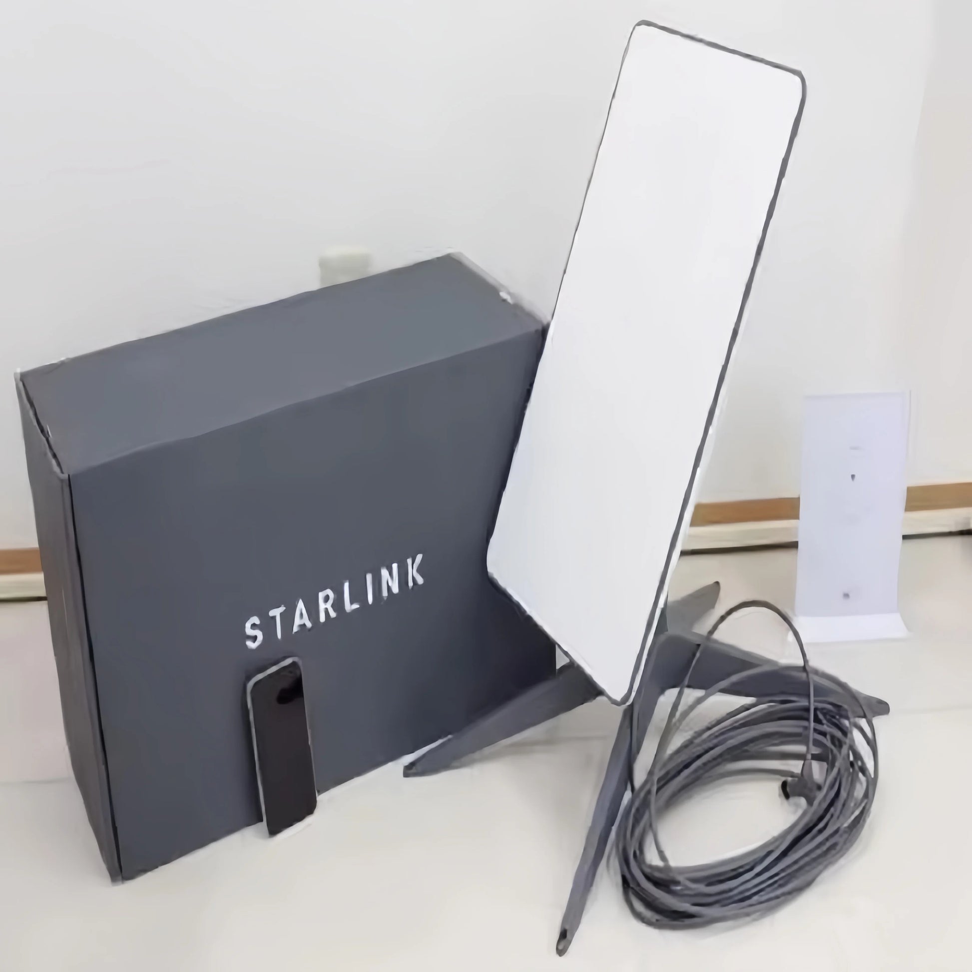Starlink Standard Satellite Internet Kit V3 and V4 with satellite dish, router, and cables, set up outdoors for high-speed internet access
