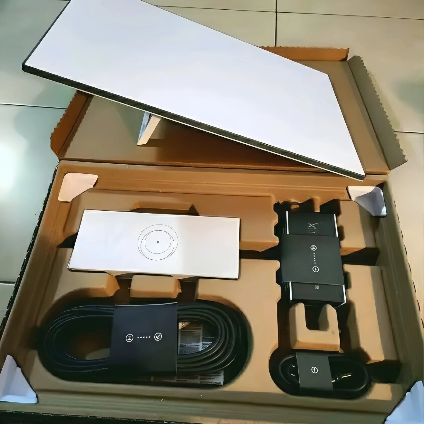 Starlink Standard Satellite Internet Kit V3 with satellite dish, modem, and accessories for high-speed satellite internet connection.