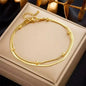 Stainless steel bohemian style personalized anklet with intricate design and adjustable chain on a white background.