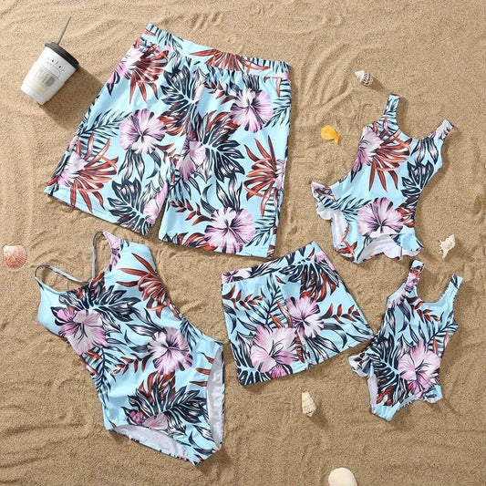 Family matching swimwear set with floral pattern, ruffle one-piece for girl, swim shorts for boy, suitable for beach wear.