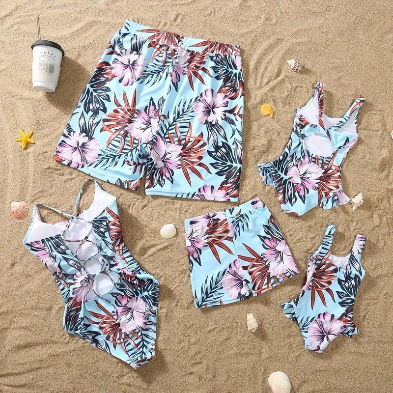 Family matching swimwear featuring floral pattern ruffle one-piece swimsuit for girl and swim shorts for boy, perfect for beachwear.