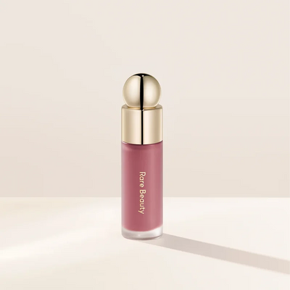 Rare Beauty liquid blush in natural, long-lasting muddy shade, featuring a glossy, moisturizing cream formula for cheeks.