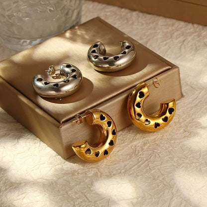 Gold-plated stainless steel hollow heart earrings with polished finish, vintage C-shape design for women.