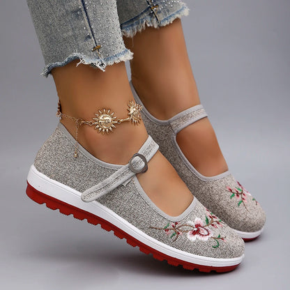 Women's breathable mesh flat sneakers in gray, casual summer shoes with a comfortable slip-on design.