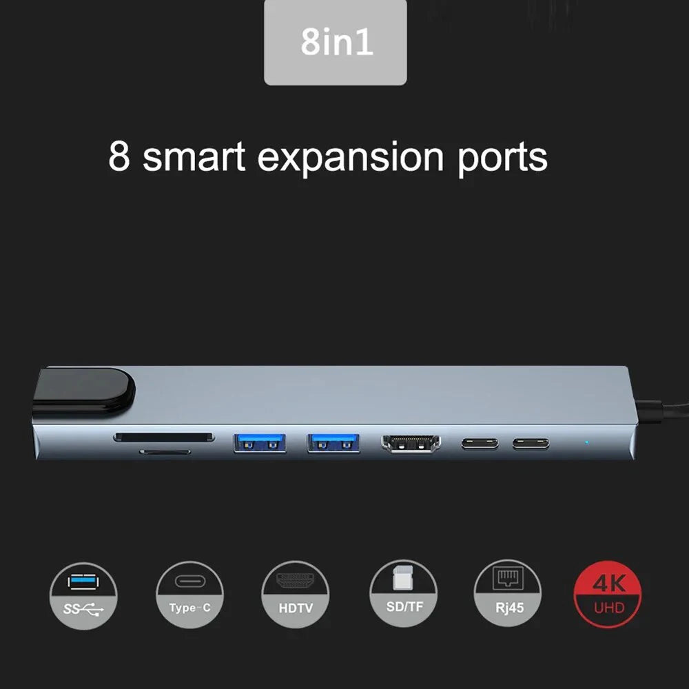 Gray USB 3.0 Type C hub with HDMI 4K, Ethernet, VGA, headphone jack, and power delivery port for laptops and desktops.