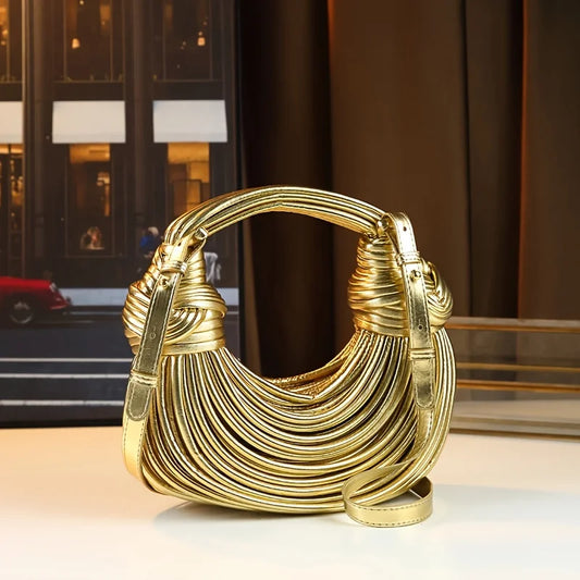 Luxury gold designer handbag for women featuring handwoven noodle design, rope knots, hobo style, and silver evening clutch details.