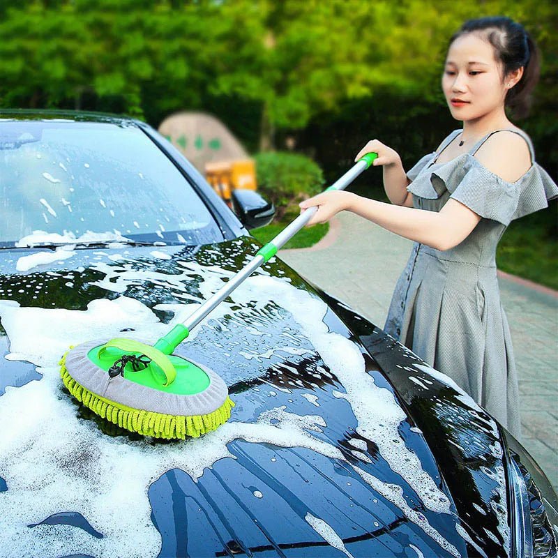 Green car cleaning brush with adjustable telescoping handle and soft absorbent bristles for detailing and auto wash.
