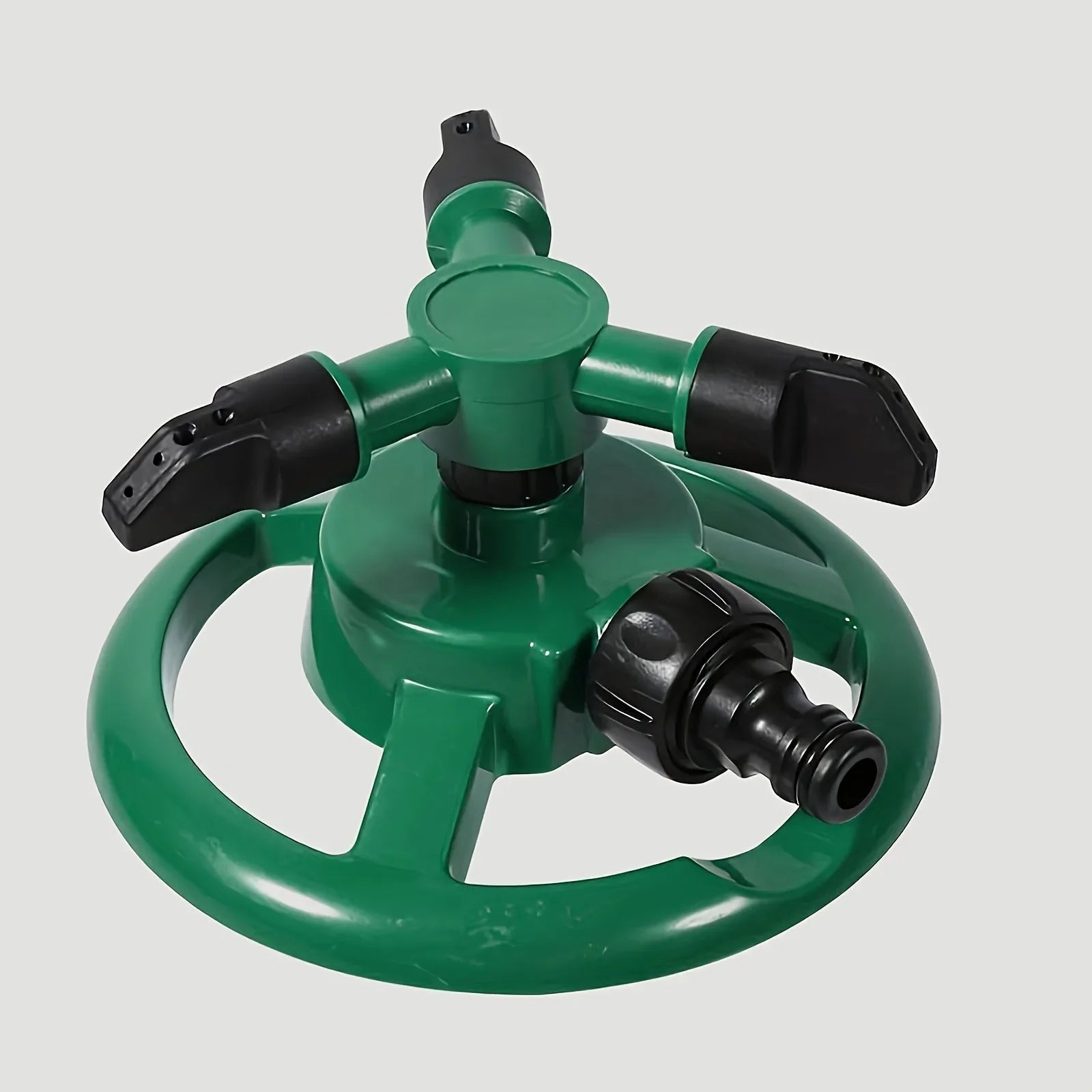 Green 360-degree automatic rotating garden sprinkler by BackupMyFilesNow for lawn watering and irrigation.