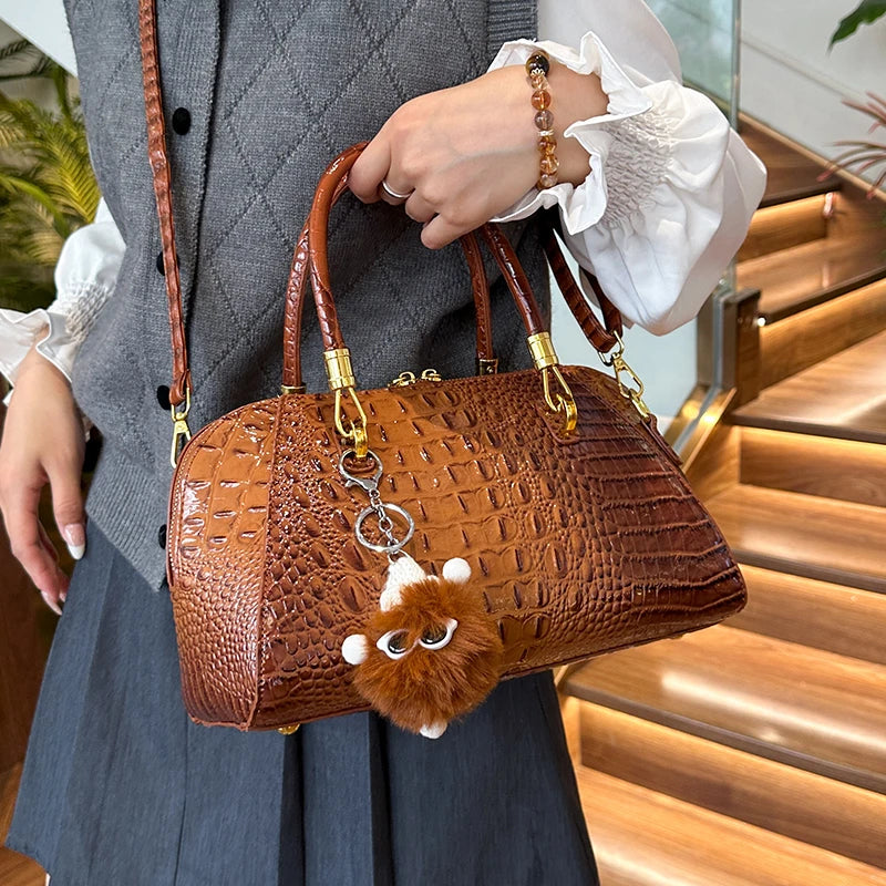 Black crocodile leather shoulder handbag for women, stylish crossbody bag with luxury designer fashion appeal.