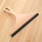 Green silicone glass scraper and squeegee for car mirrors, windows, shower, and bathroom cleaning with brush holder.