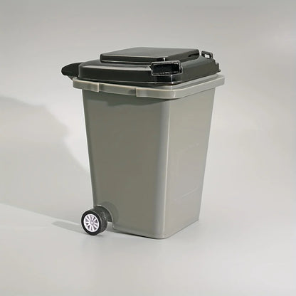 Grey portable mini office desk trash bin and pen holder for office supplies storage, compact and convenient for workspace organization.