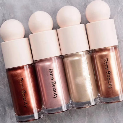 Rare Beauty liquid blush cream with sheer dewy finish, portable multi-use cheek and lip tint, blendable and gentle makeup product.