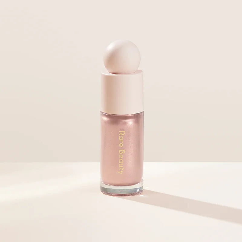 Rare Beauty liquid blush cream with sheer dewy finish, portable multi-use cheek and lip tint, gentle and blendable makeup product.