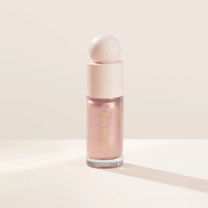 Rare Beauty liquid blush cream with sheer dewy finish, portable multi-use cheek and lip tint, gentle and blendable makeup product.