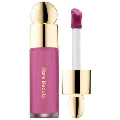 Rare Beauty liquid blush cream with dewy finish, portable multi-use cheek and lip tint, perfect for natural, gentle makeup looks.