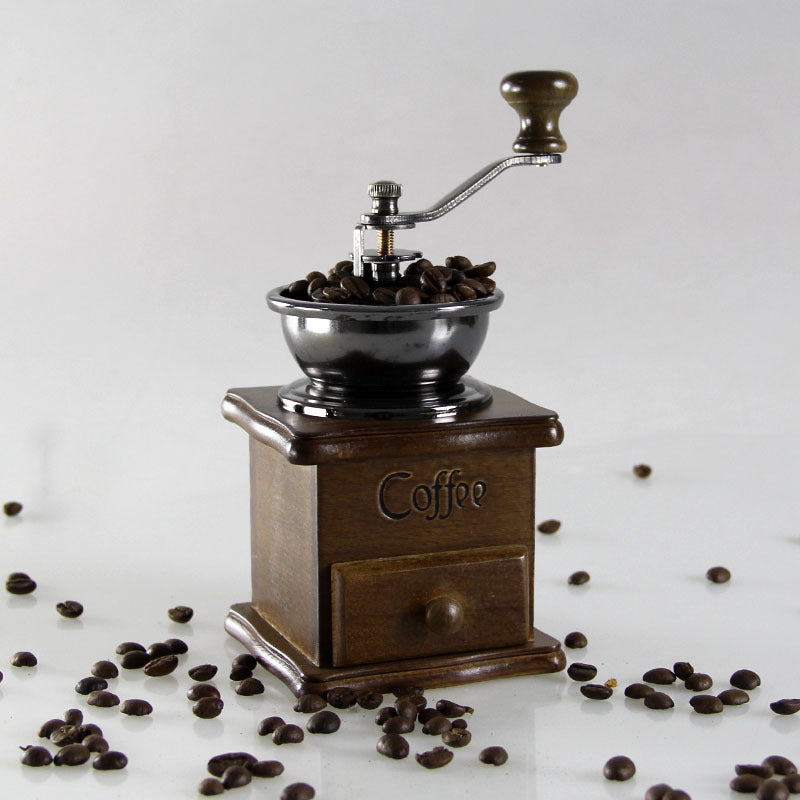 Manual coffee grinder from BACKUPMYFILESNOW.COM® with a compact design, featuring a ceramic burr and wooden handle for home use.