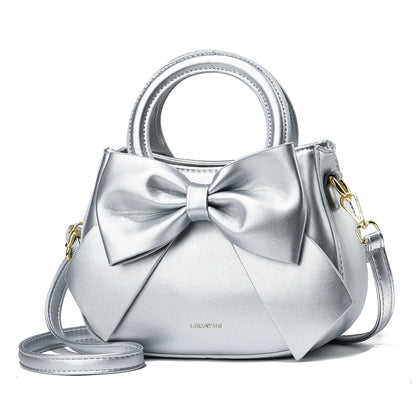 Khaki women's crossbody bag with top handle, bow tie accent, shoulder strap, and tote style, from BACKUPMYFILESNOW.COM®