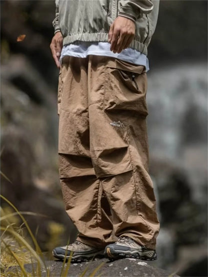 Men's waterproof hip hop mountaineering pants by BACKUPMYFILESNOW.COM®, black cargo outwear pants for spring and autumn outdoor activities.