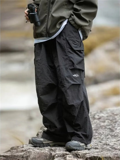 Men's waterproof hip hop mountaineering pants by BACKUPMYFILESNOW® in black, casual Harajuku work cargo outdoor pants for spring and autumn.