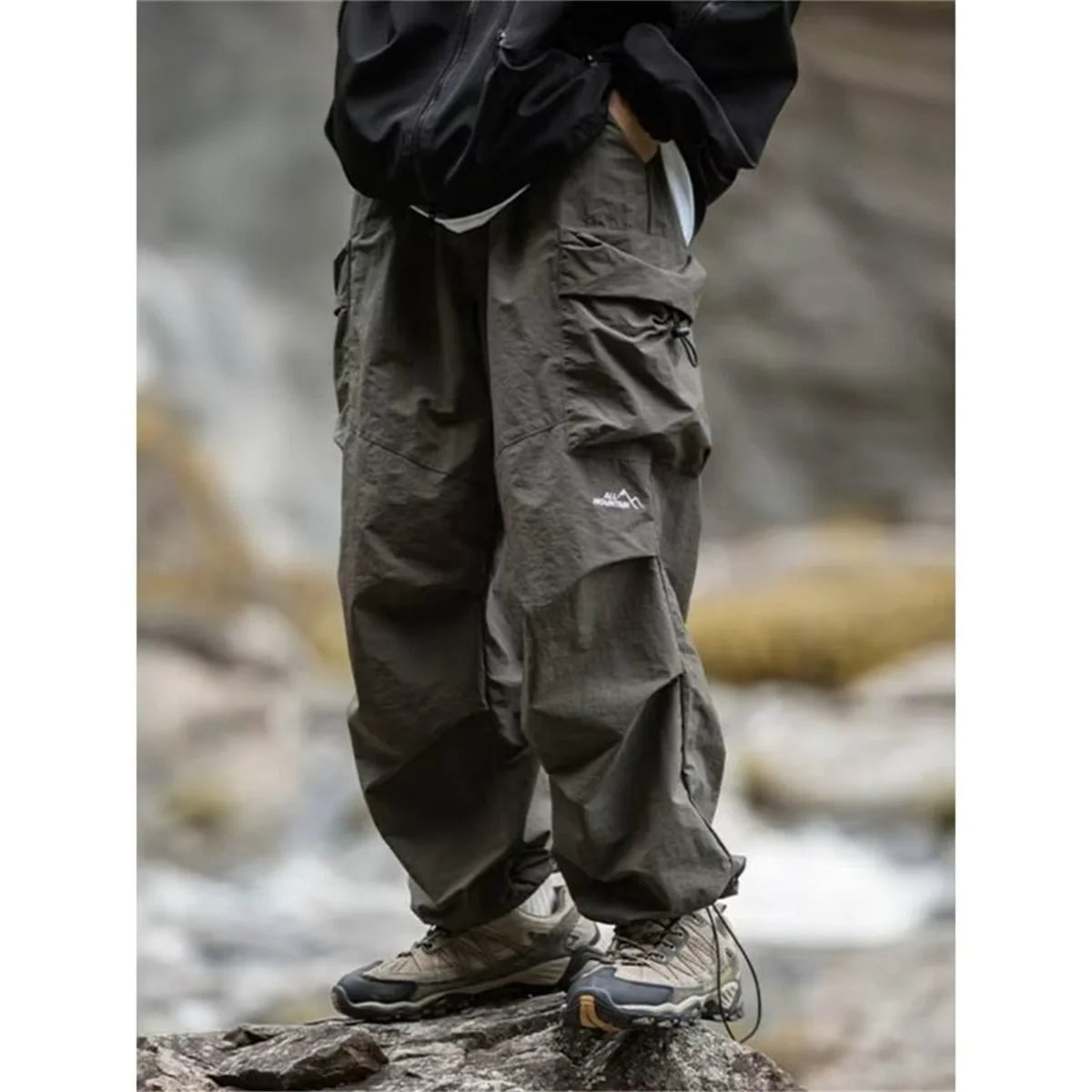 Men's waterproof hip-hop mountaineering pants in black, casual Harajuku work style, suitable for spring and autumn outdoor activities.