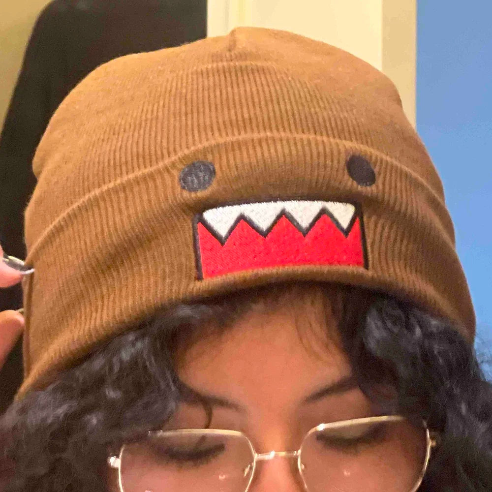 Domo Kun embroidered knitted hat in khaki, featuring a cartoon design, warm, windproof, stylish for men and women in autumn winter outdoor wear.