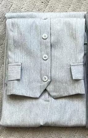 Tailored vest and long skirt set by BACKUPMYFILESNOW.COM®, featuring a fitted vest and flowing skirt in neutral fabric.