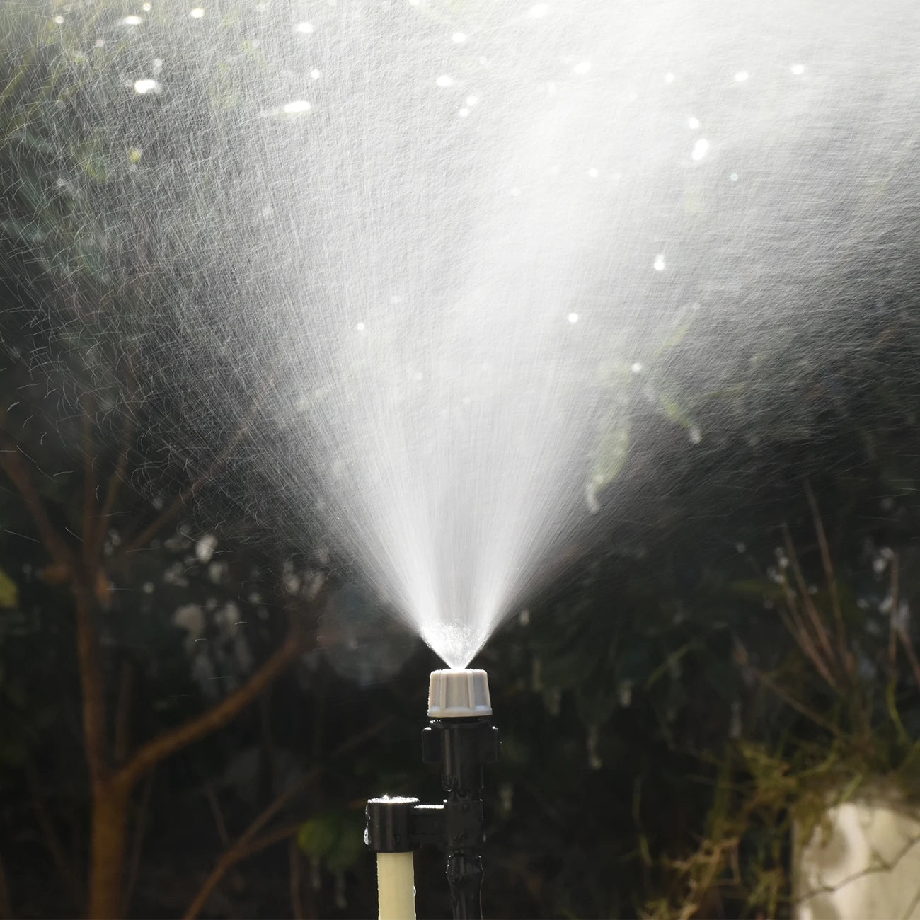 Set of 20 plastic watering irrigation garden misting sprinkler heads with nozzles and T-joint connectors for garden misting systems.