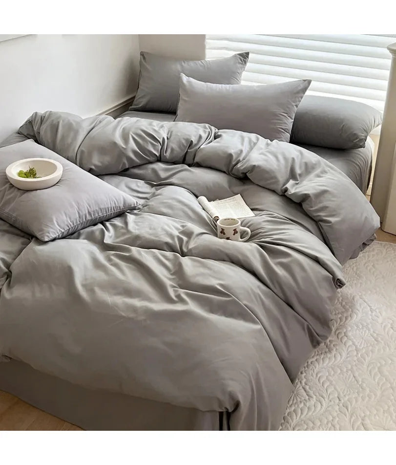 Light gray solid cotton bedding set with sheet, duvet cover, and pillowcases in king, queen, double, twin sizes.