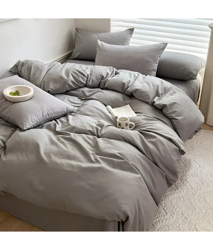 Light gray solid cotton bedding set with sheet, duvet cover, and pillowcases in king, queen, double, twin sizes.