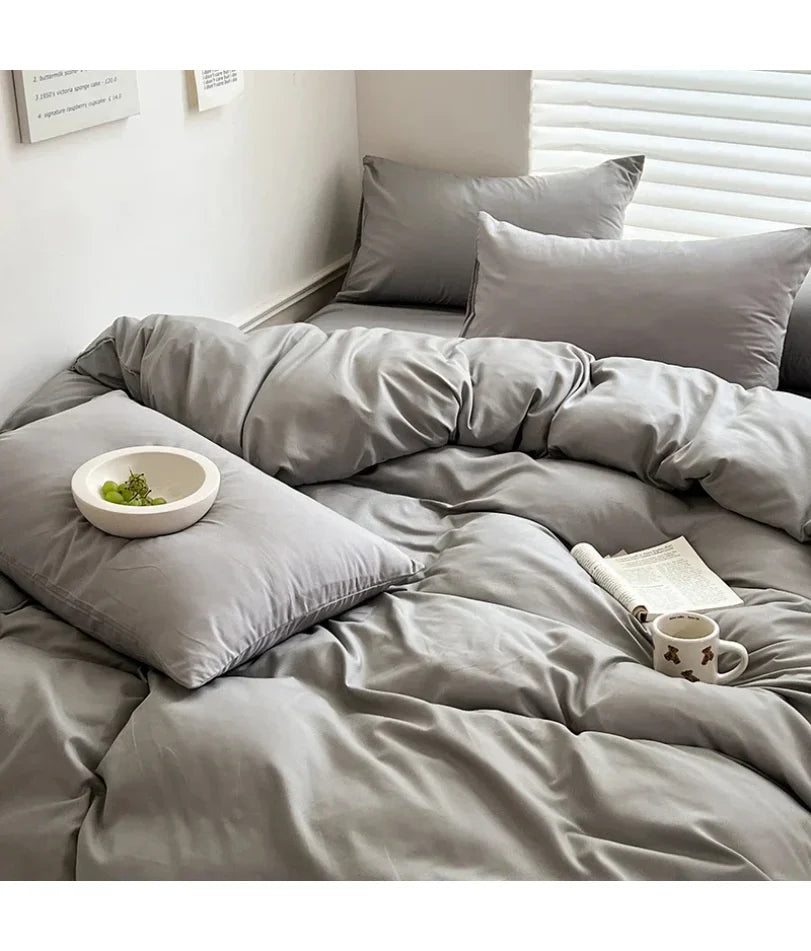 Light gray solid cotton bedding set with duvet cover, pillowcases, and sheets for single, double, queen, and king beds.