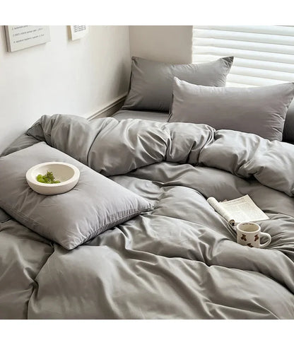 Light gray solid cotton bedding set with duvet cover, pillowcases, and sheets for single, double, queen, and king beds.
