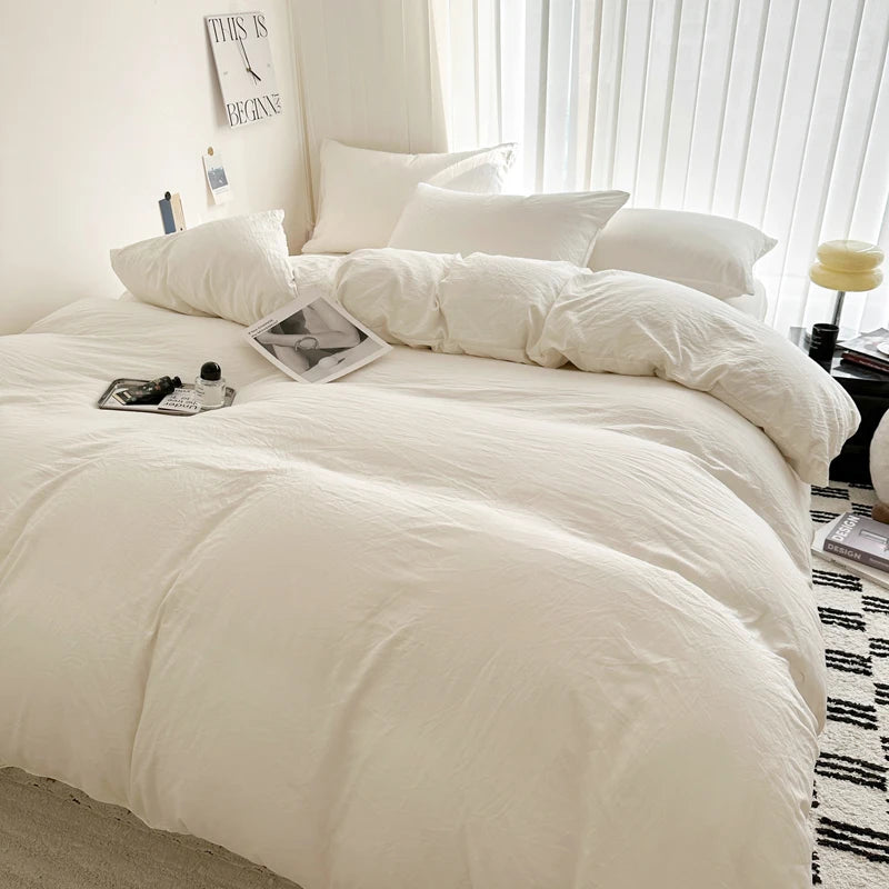 Light gray cotton bedding set with duvet cover, pillowcases, and sheets in various sizes, featuring solid bed linen design.