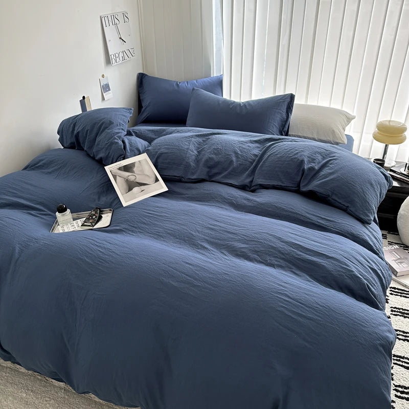 Light gray solid cotton bedding set with duvet cover, pillowcases, and sheet for single, double, queen, or king beds.