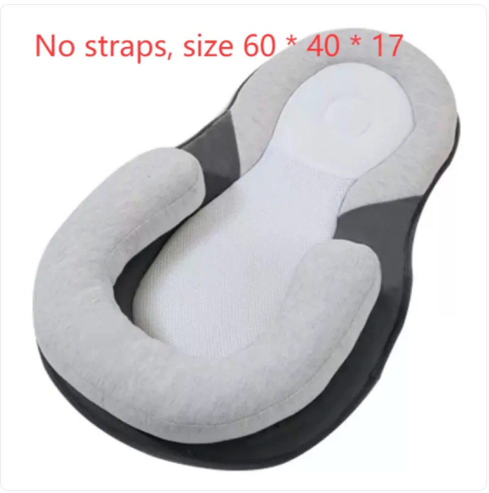 Light grey baby anti-spit up pillow with safety strap for comfort and support during feeding.