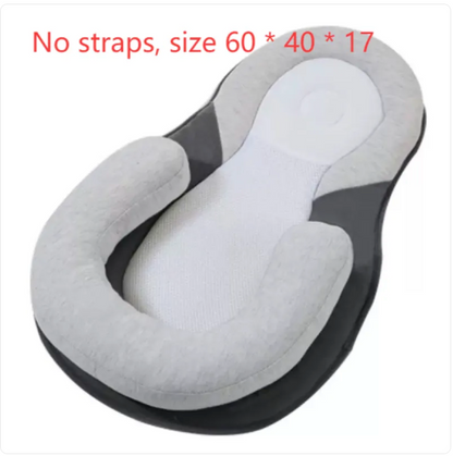 Light grey baby anti-spit up pillow with safety strap for comfort and support during feeding.