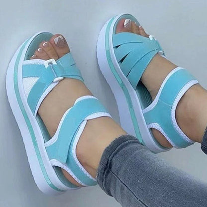 Light blue women's summer wedge sandals with outdoor walking and beach footwear style, featuring open-toe design and ankle straps.
