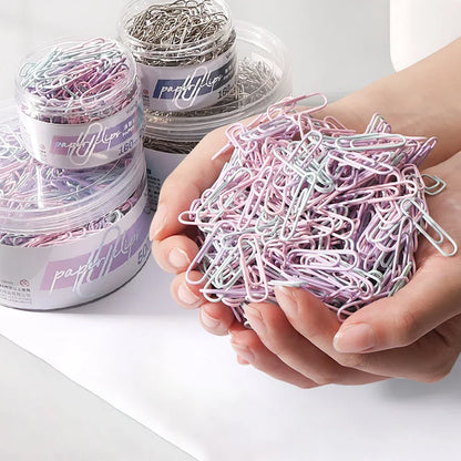 Assorted colorful paper clips in a storage box, ideal for office supplies, large file bookmarks, and stationery organization.