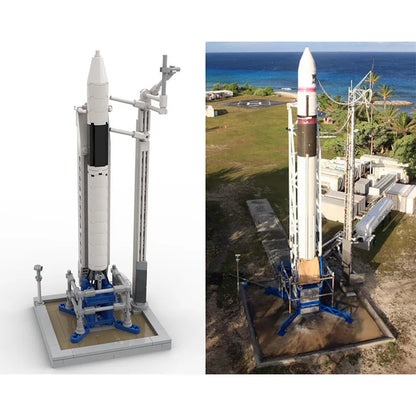 Scale model of SpaceX Falcon 1 rocket with launch building blocks, featuring Saturn V and Falcon 9, universe-themed artificial satellite.