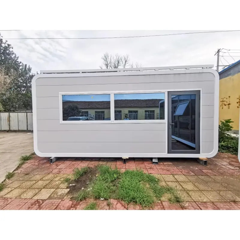 Two-storey modular tiny house with steel structure, prefab design, featuring large windows and modern luxury villa style.